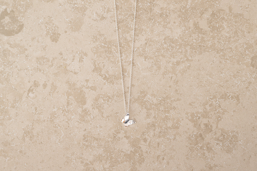Butterfly necklace i 925 sterling silver från By K Design på beige bakgrund.