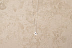 Butterfly necklace i 925 sterling silver från By K Design på beige bakgrund.